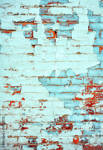 Terra cotta red brick wall with blue peeling paint background