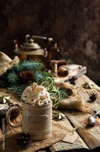 Fototapeta Naklejka Na Ścianę i Meble -  ceramic mug with hot cocoa, chocolate or coffee with whipped cream and christmas candy canes