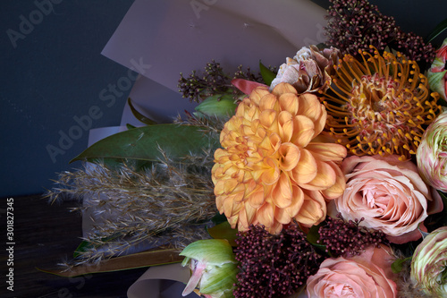 Close-up bouquet decorated in vintage style on a dark background, selective focus photo