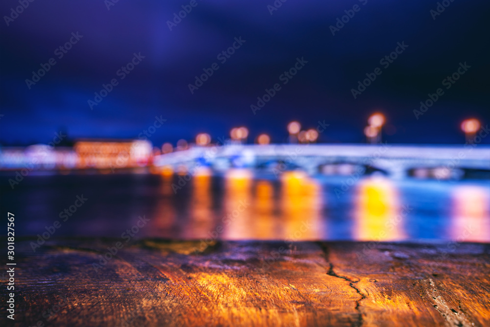 Empty Wooden Table with a View of Blurry Evening City. Backdrop for Product Placement