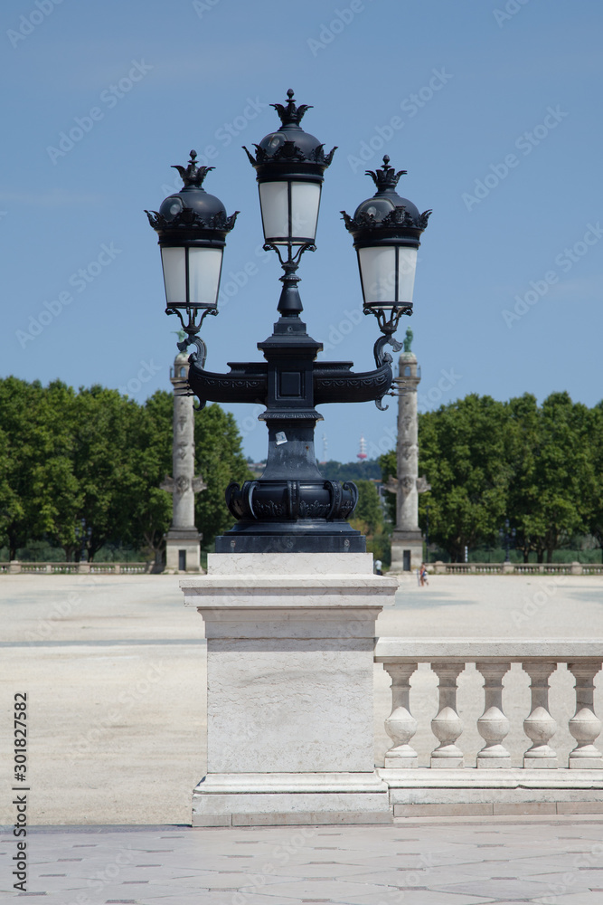 Bordeaux street light effect with statues bordering the square of Quinconces