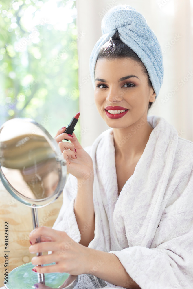Beautiful woman applying red lipstick. Woman getting ready for outgoing Beautiful woman applying red lipstick. Woman getting ready for outgoing