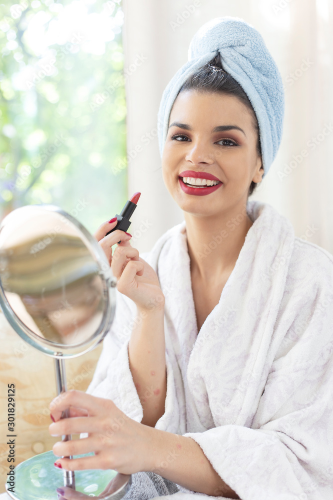 Beautiful woman applying red lipstick. Woman getting ready for outgoing Beautiful woman applying red lipstick. Woman getting ready for outgoing