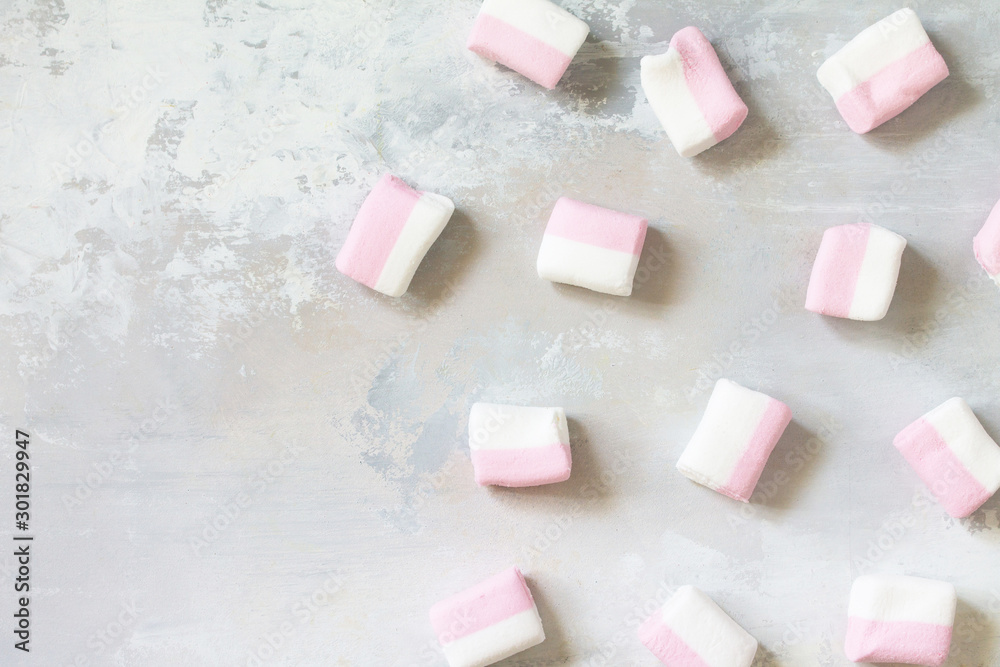 Marshmallows marshmallows isolated on light gray stone background. Top view flat lay background. Marshmallows marshmallows isolated on light gray stone background. Top view flat lay background.