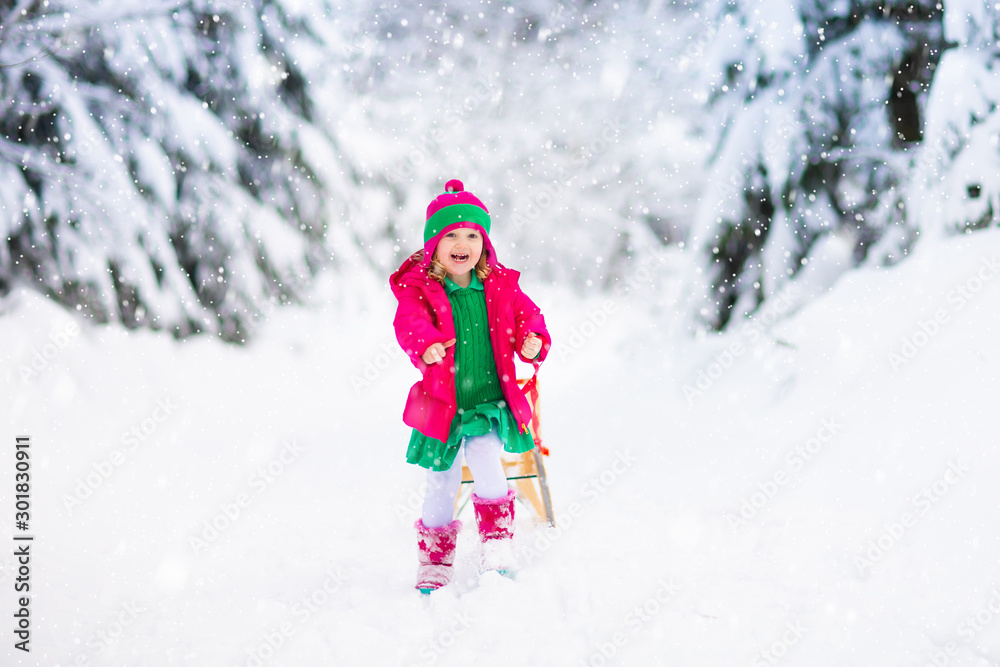 Girl on sled ride. Child sledding. Kid on sledge Girl on sled ride. Child sledding. Kid on sledge