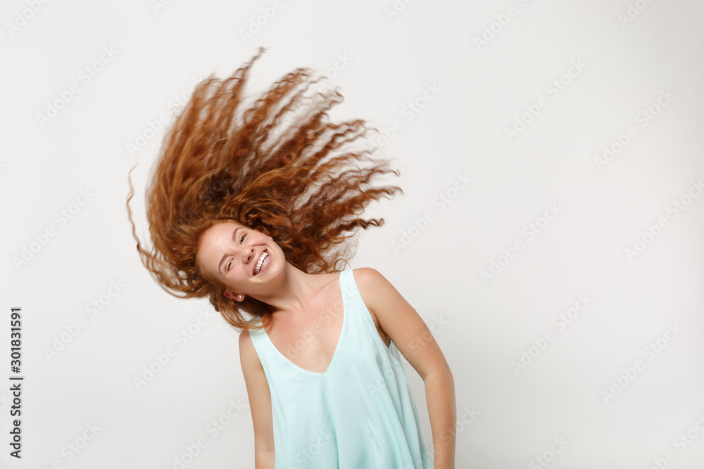 Young smiling redhead woman girl in casual light clothes posing isolated on white background in studio. People lifestyle concept. Mock up copy space. Having fun, fooling around with fluttering hair. Young smiling redhead woman girl in casual light clothes posing isolated on white background in studio. People lifestyle concept. Mock up copy space. Having fun, fooling around with fluttering hair.