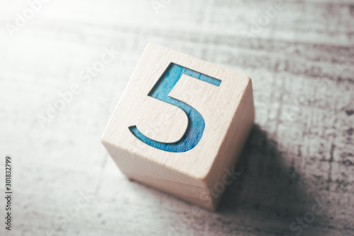 Number 5 On A Wooden Block On A Table