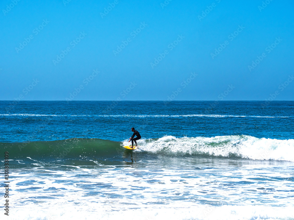 California Surfer and his yellow Board riding the waves California Surfer and his yellow Board riding the waves