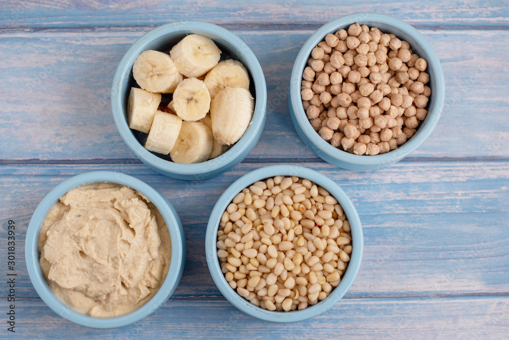 ingredients for making smoothies in bowls - banana, hummus, chickpea and pine nuts ingredients for making smoothies in bowls - banana, hummus, chickpea and pine nuts