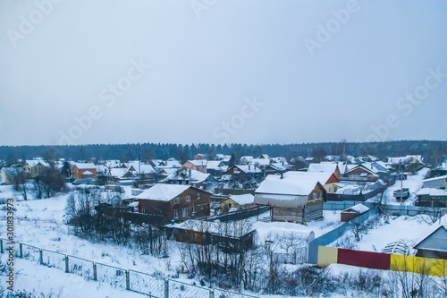 Winter landscape - a village in the snow at sunrise