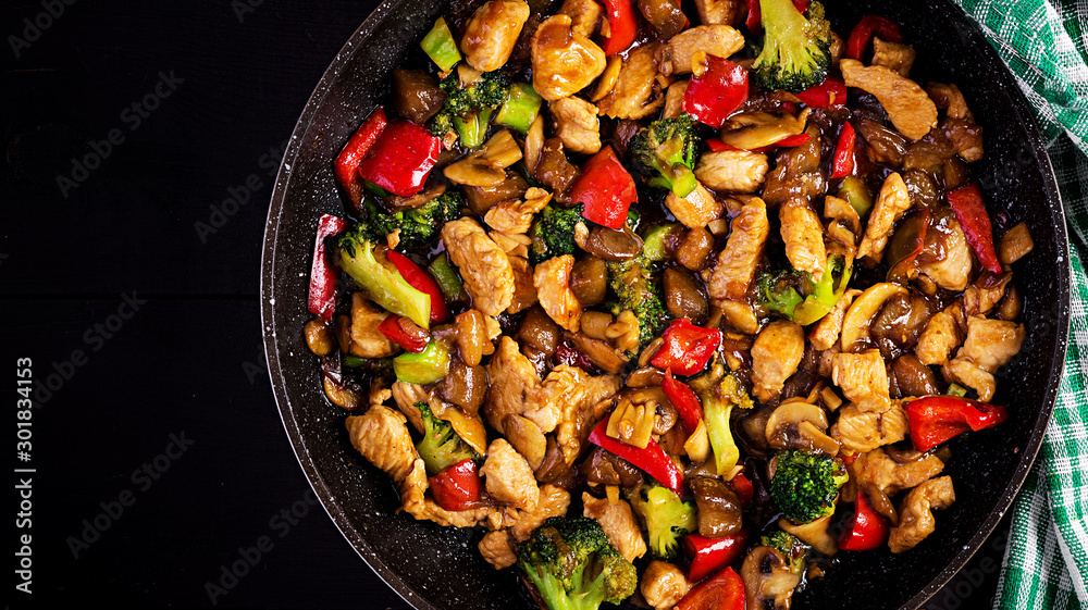 Stir fry with chicken, mushrooms, broccoli and peppers. Chinese food. Top view, overhead