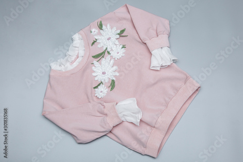 Children's stylish Pink Color Sweat-shirt on grey background. Top view