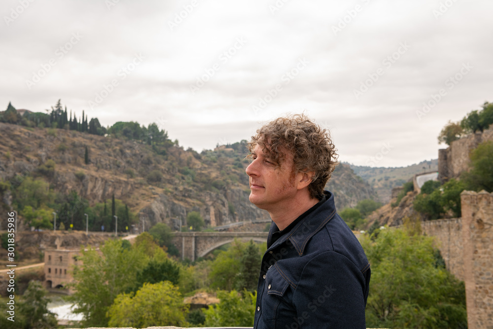 A man overlooks the scenery of the beautiful,historic city of Toledo, Spain.