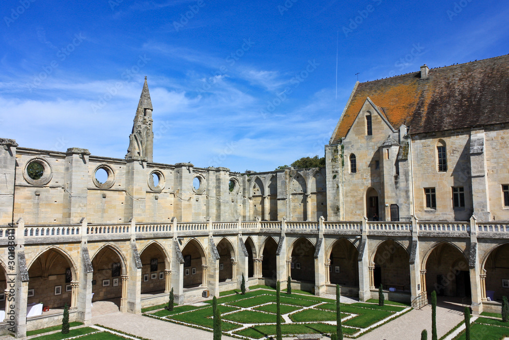 Royaumont Cistercian Abbey cloister in sunny day. Ile-de-France region, France.
