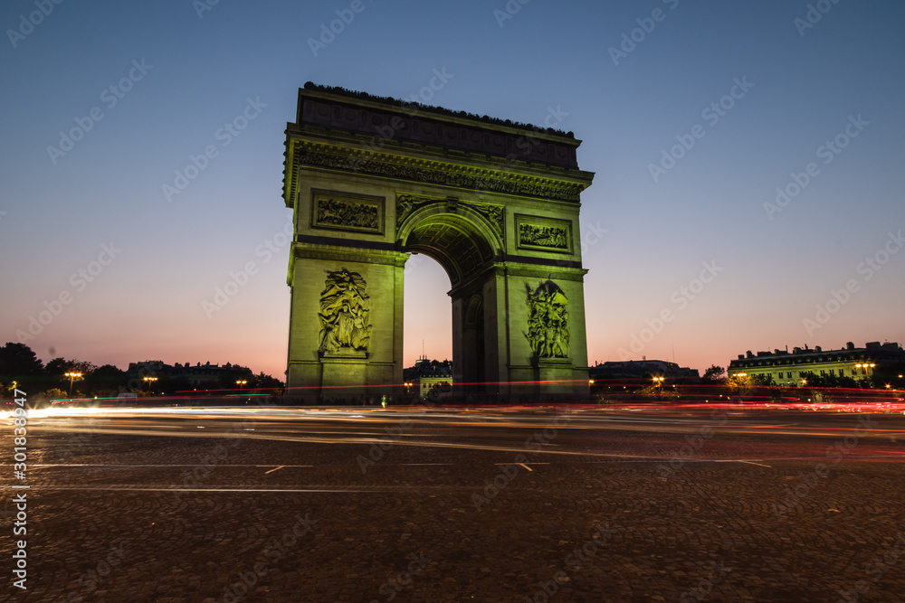 The Arc de Triomphe de l'Étoile illuminated at night, Paris