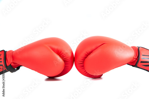 Red boxing gloves isolated on white. The concept of sport and active leisure. On the table are red boxing gloves, kickboxing. Playing sports, taking care of your figure, fight and self-defense. © Sebastian