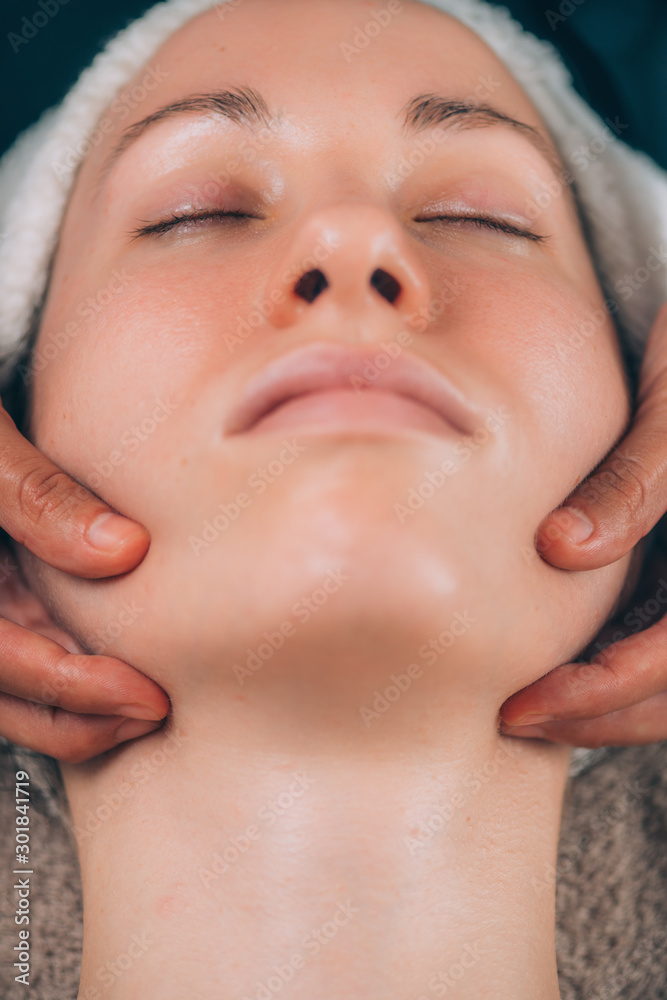 Beautiful Woman Receiving Chin and Jaw Skin Lifting Massage