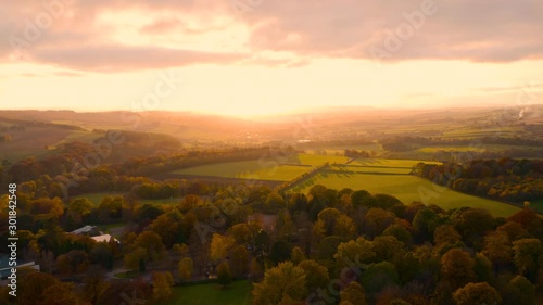 Aerial panning footage in Fall of an Autumn sunset over English Rural Countryside near Yorkshire Sculpture park