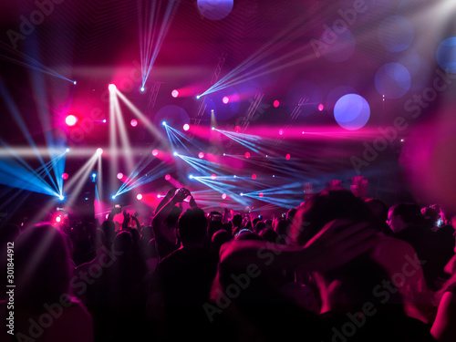 People on the dance floor pink and blue lights