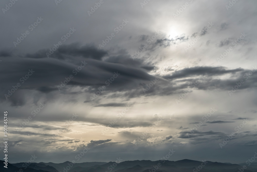 Cloudy sky with thunderclouds covering the sun
