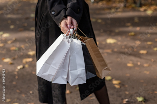 Closeup of woman holding shopping bags on the street. Shopping or sale concept.