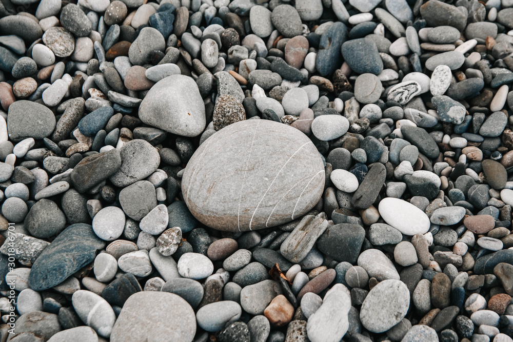 Gravel pattern of colored stones. Abstract nature pebbles background. Stone background. Sea peblles beach. Top view. Gravel pattern of colored stones. Abstract nature pebbles background. Stone background. Sea peblles beach. Top view.