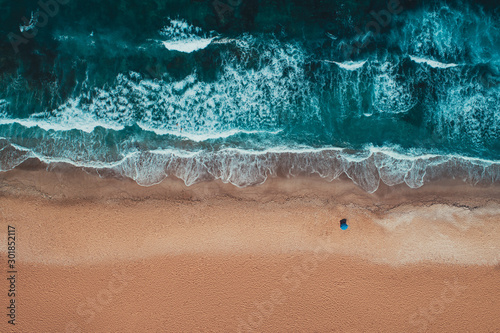 Aerial top view from drone of sandy beach with turquoise sea waves with copy ...