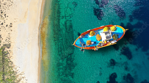 Aerial drone top down photo of traditional fishing boat near famous beach of Vagia, Serifos island, Cyclades, Greece