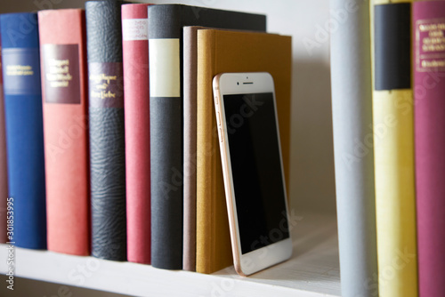 Sideview of mobile phone in bookshelf