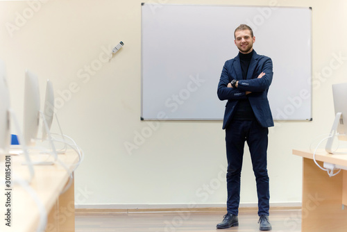 Confidence and business concept. Portrait of charming successful young businessman.