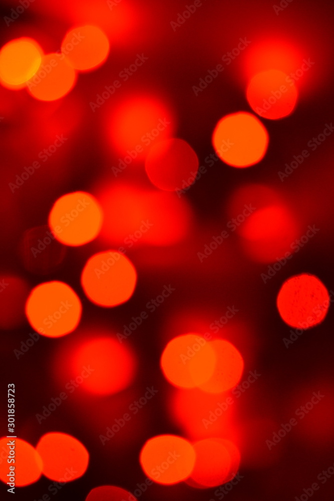 Christmas, New Year holidays background. Lights on red and orange defocus bokeh disco effect. Abstract christmas lights garland.