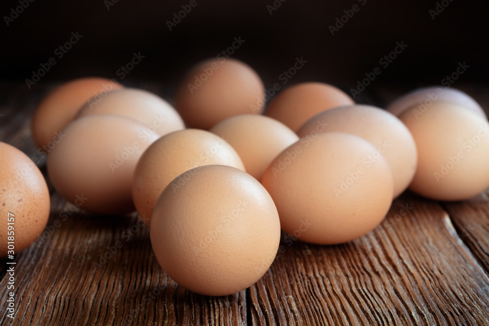 set of raw chicken eggs on wooden table set of raw chicken eggs on wooden table