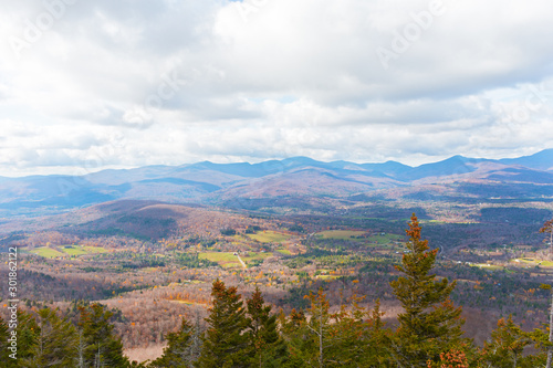 Mountainous landscape on a cloudy day in late autumn. Autumn panorama in vicinity of Stowe, Vermont, USA. © avmedved
