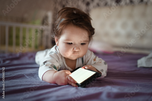 child look at the screen of a mobile phone with a white blank screen: layout of a mobile application for mom and baby