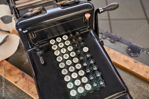 Vintage calculator and cash register on a counter photo