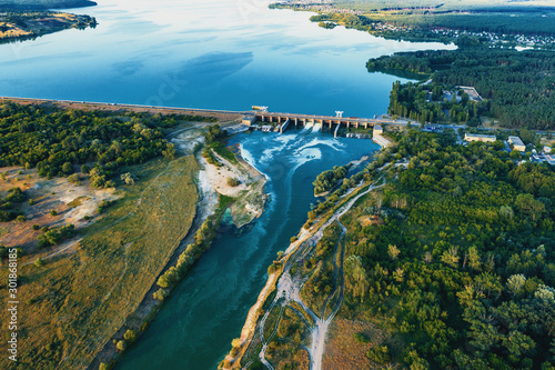 Fototapeta Naklejka Na Ścianę i Meble -  Aerial view of Dam at reservoir with flowing water, hydroelectricity power station, drone photo.