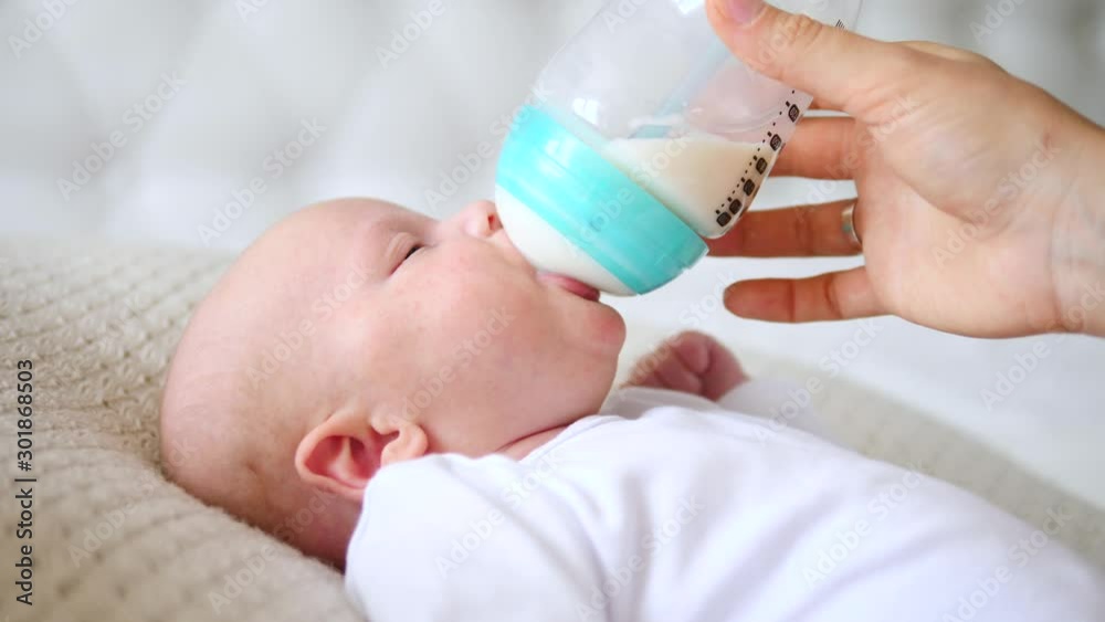 Artificial Feeding Concept. Baby Drinking Formula From The Bottle. Artificial Feeding Concept. Baby Drinking Formula From The Bottle.