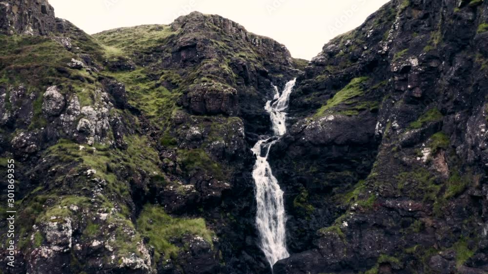 Beautiful Waterfall in Inland of Scottish Island Isle of Skye, Ascending Aerial Revealing Landscape With Meadow and Sheeps Laying in Grass Beautiful Waterfall in Inland of Scottish Island Isle of Skye, Ascending Aerial Revealing Landscape With Meadow and Sheeps Laying in Grass