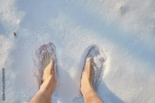 Barefoot in snow, standing or walking, first person point of view