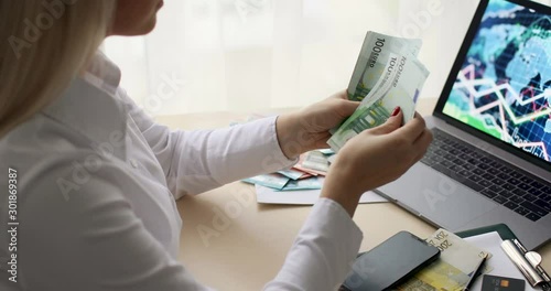 Business Woman Counting Money. Close up of female hands counting euro banknotes.