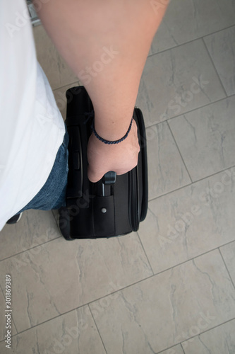 Man's hand carrying luggage photo