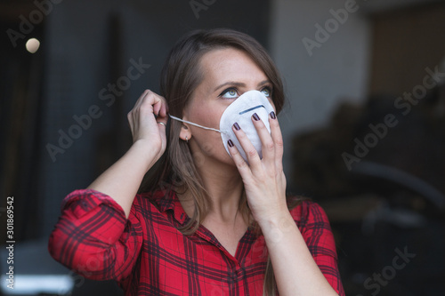 Young woman putting face mask for polluted air