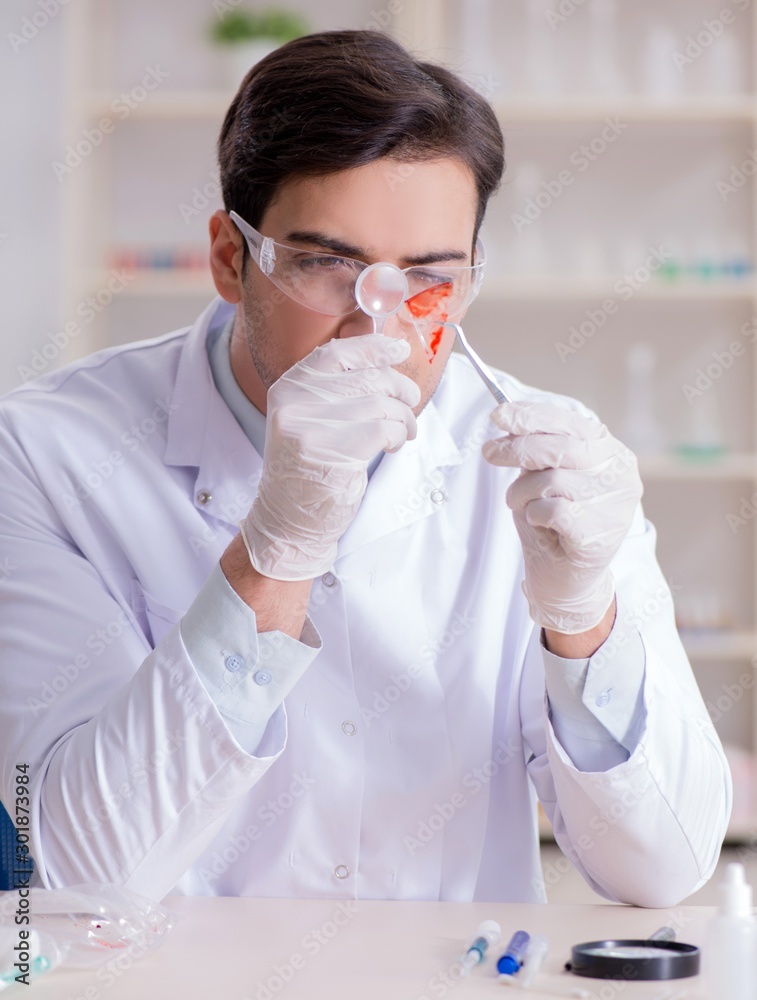 Expert criminologist working in the lab for evidence Expert criminologist working in the lab for evidence
