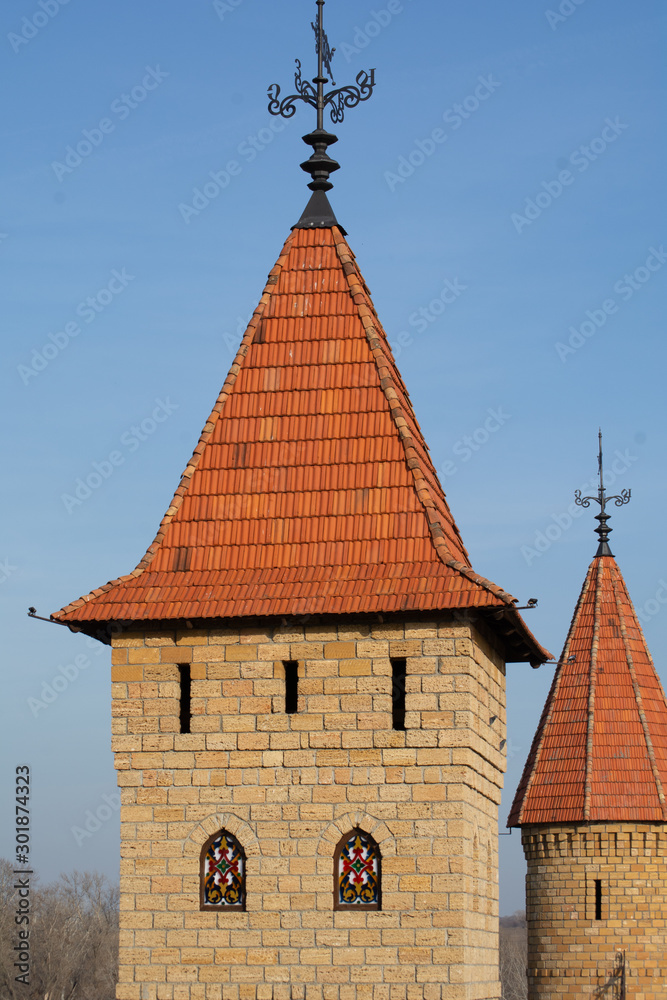 Castle towers with tiled roofs against the blue sky Castle towers with tiled roofs against the blue sky