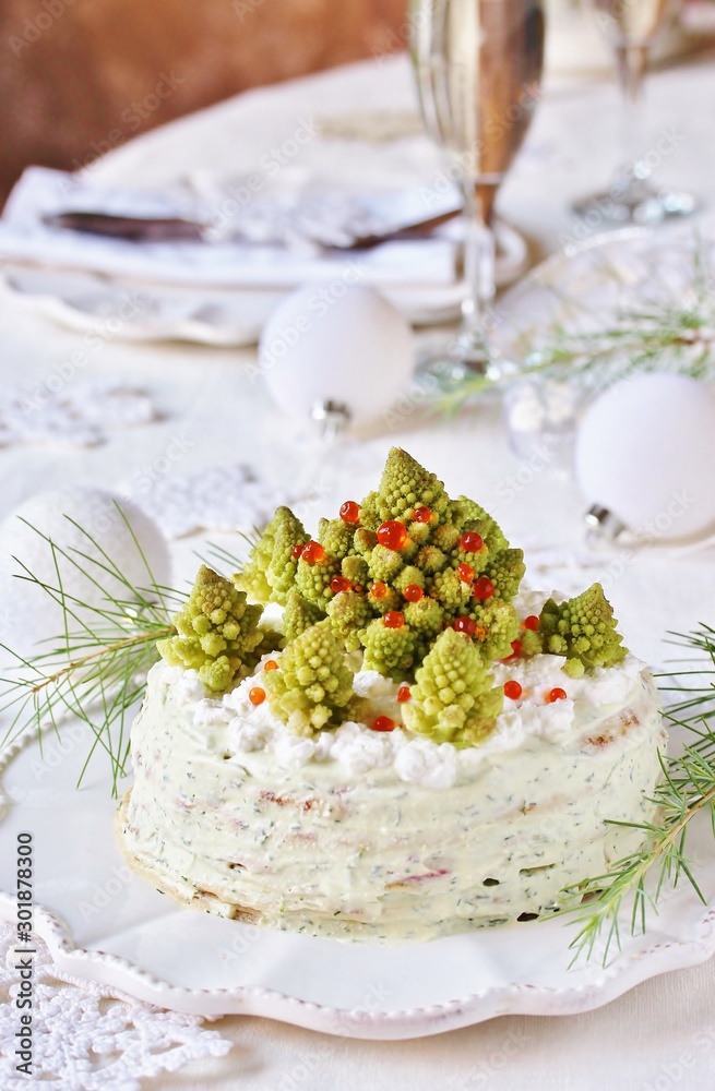 crep cake for Christmas and New Year. Christmas tree decorations cabbage romanesco. Snack cake with salmon, avocado and soft cheese. Grains of cottage cheese play the role of snowdrifts. crep cake for Christmas and New Year. Christmas tree decorations cabbage romanesco. Snack cake with salmon, avocado and soft cheese. Grains of cottage cheese play the role of snowdrifts.