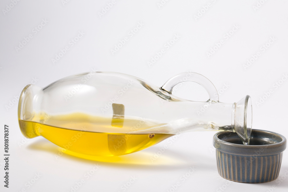 Olive oil in a bottle on white Olive oil in a bottle on white