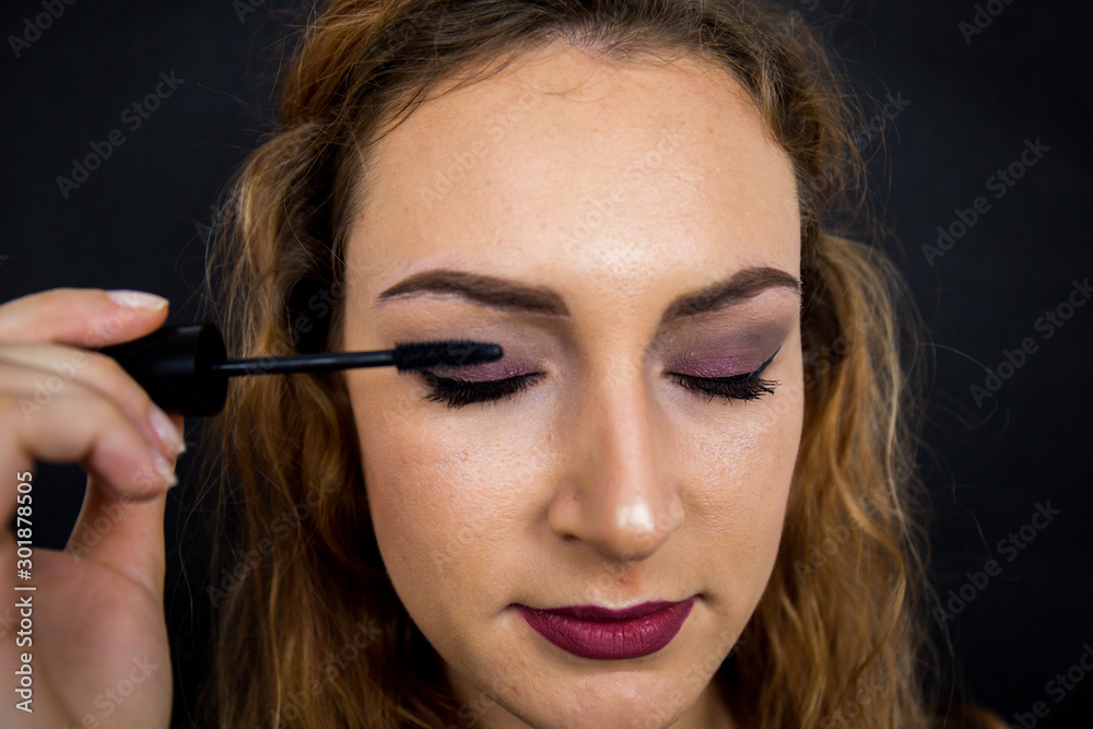 Portrait, beautiful girl, make-up, with smile posing on black background, makeup, powder, eye shadow, mascara, lipstick, eyeshadow Portrait, beautiful girl, make-up, with smile posing on black background, makeup, powder, eye shadow, mascara, lipstick, eyeshadow