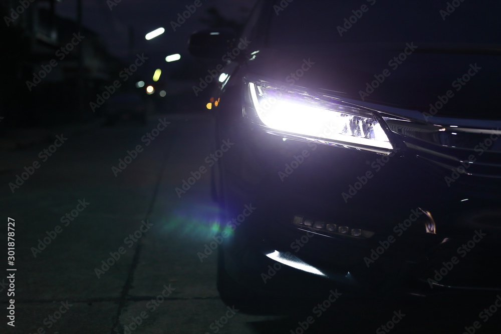headlight vehicle car open low light beam in the night urban road - obrazy, fototapety, plakaty 