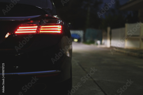 red taillight of modern sport car in the night street © sutichak