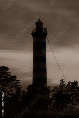 High lighthouse tower silhouette in the dark